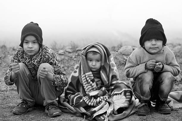 istock Poor Children Sitting in Winter Season 476151400
