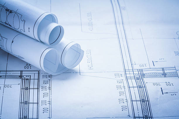 istock Some rolled up construction drawings building and architecture c 476152226