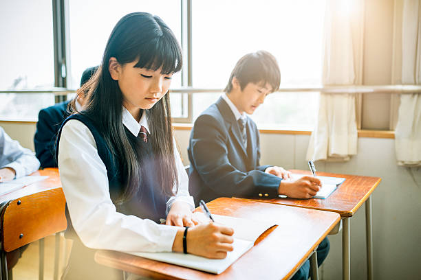 Japanese High School Exams Japanese Junior High School Students filling an exam. learning japanese stock pictures, royalty-free photos & images
