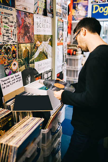istock Male searching for second hand vinyl records, record store 476156350