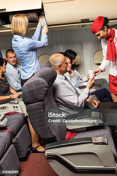 Flight Attendant Check Passenger Tickets Cabin Stock Photo - Download Image Now - Adult, Air Stewardess, Air Vehicle