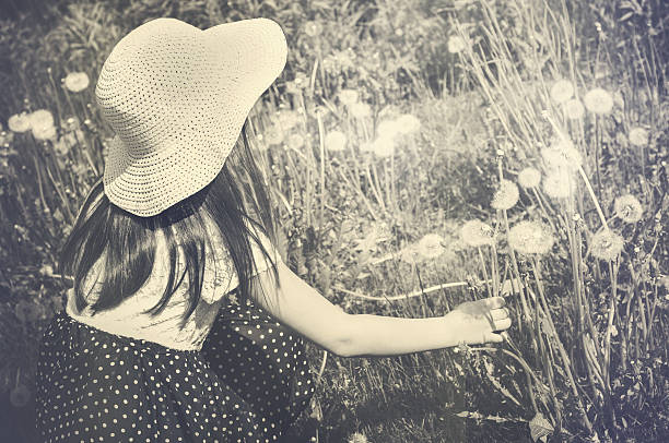 Little girl on a blossoming meadow stock photo