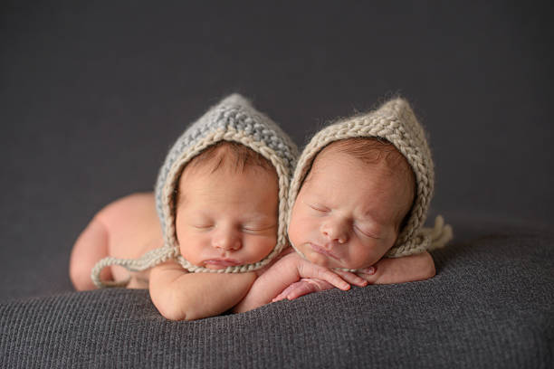 istock Newborn Twins Sleeping in Knit Hats 476164105