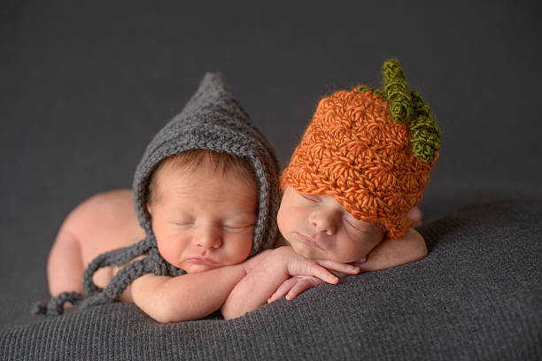 istock Newborn Twins Sleeping in Knit Hats 476164111