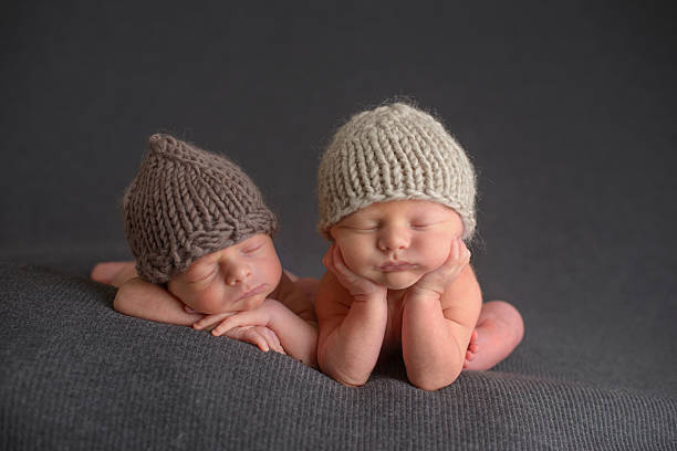 istock Newborn Twins Sleeping in Knit Hats 476164113