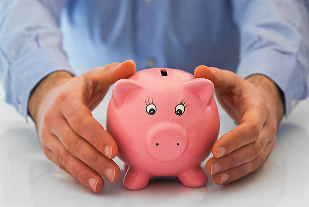 istock Man with piggy bank. 476164150