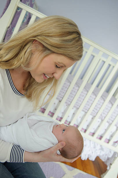 istock Newborn Girl Looking at her Mommy 476164651
