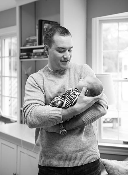 istock Dad Holding Newborn Daughter 476164681
