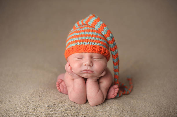 istock Newborn Sleeping in a Colorful Knit Hat 476164859