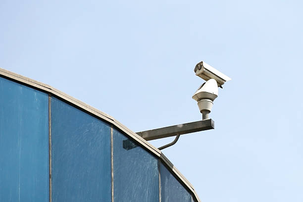 istock Security camera on top of building watching the entrance 476170150