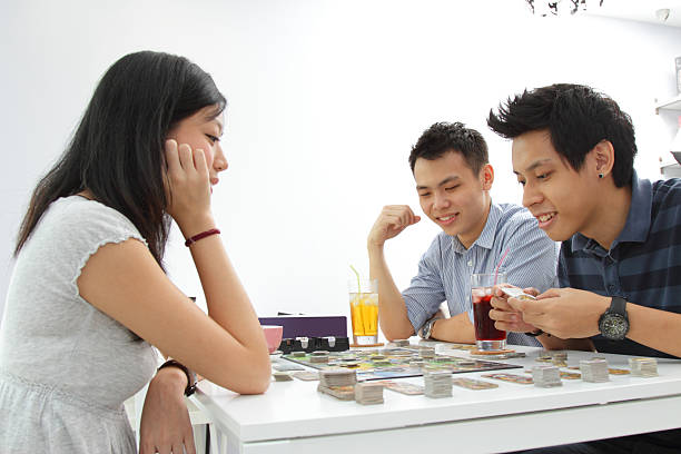 Friends playing a board game stock photo