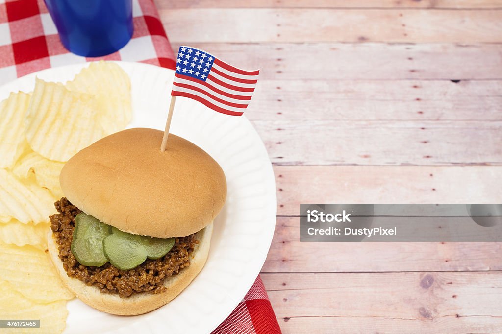 Patriotic Sloppy Joe Sloppy Joe sandwich with a US Flag, pickle and chips American Flag Stock Photo