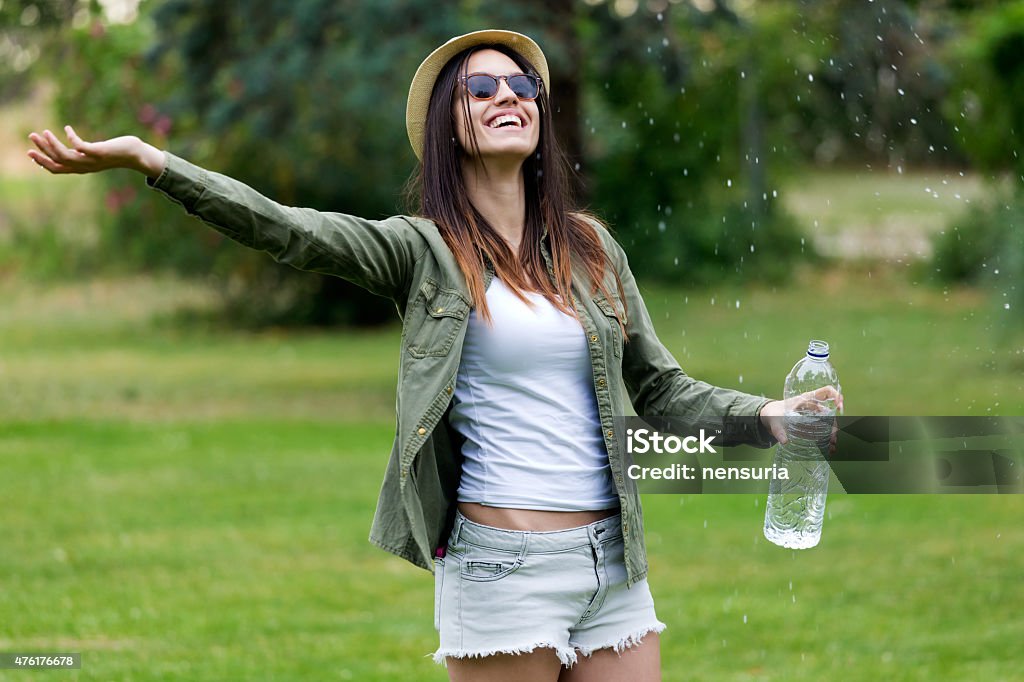 Beautiful young woman enjoying summer with water. Portrait of beautiful young woman enjoying summer with water. Below Stock Photo