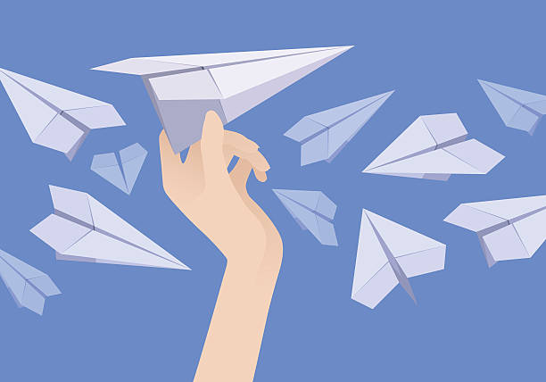 istock White paper airplane in the female hand and other planes 476176688