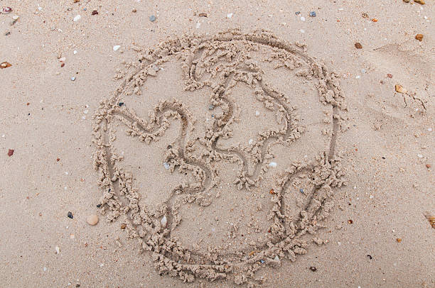 istock The word world handwritten in sand 476177085