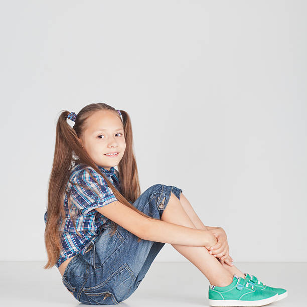 istock Beautiful girl sitting on the floor 476177143