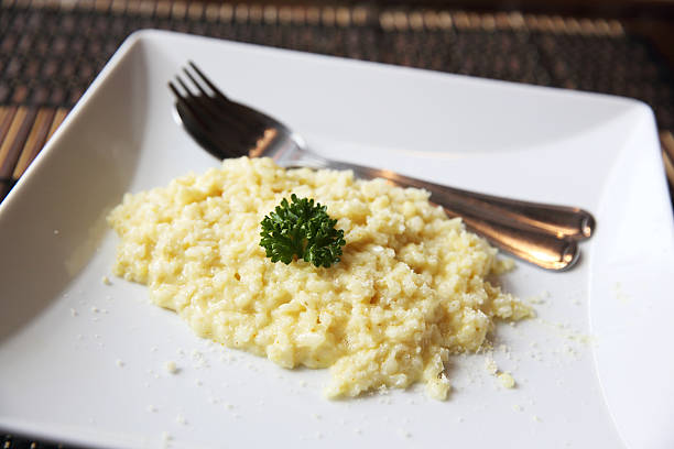 istock risotto dish with herbs on wood background 476180714