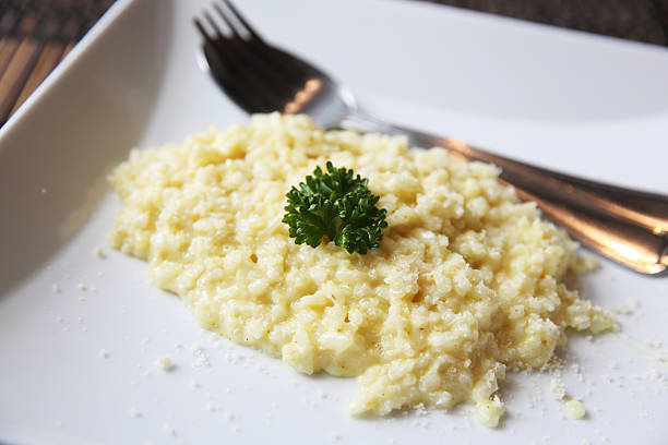 istock risotto dish with herbs on wood background 476180716
