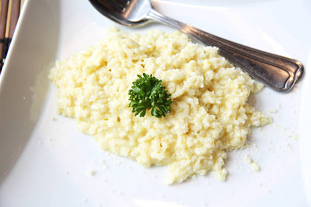 istock risotto dish with herbs on wood background 476180746
