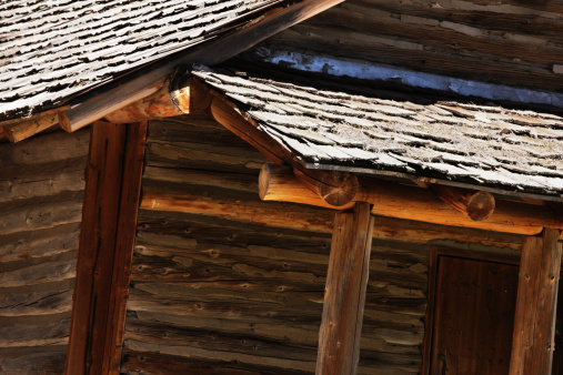 Close crop on architectural detail of a log cabin facade, porch, roof.  Coconino National Forest, Arizona, 2013.