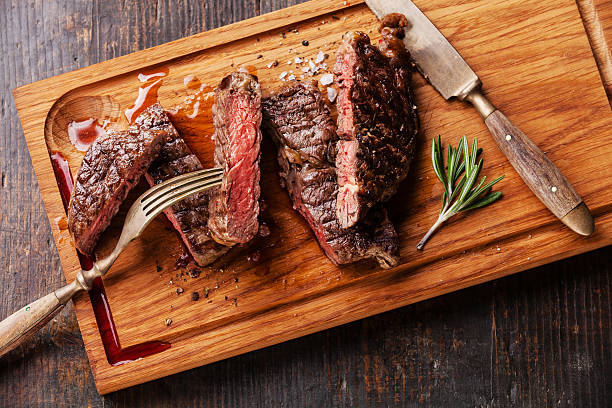 istock Sliced medium rare grilled steak Ribeye with rosemary 476185078