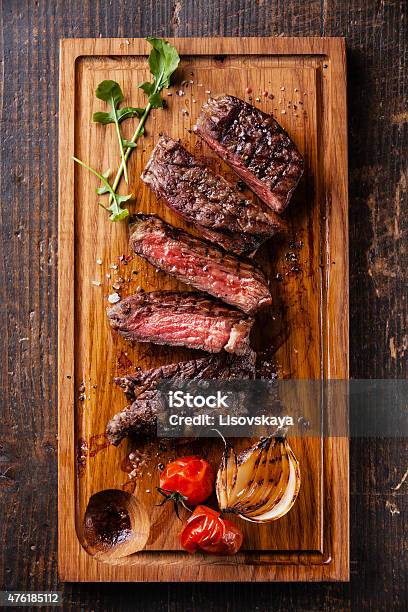 Sliced Medium Rare Grilled Steak Ribeye With Grilled Onions Stock Photo - Download Image Now