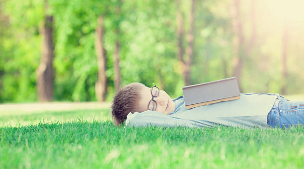 istock young boy with a book slipping 476187804