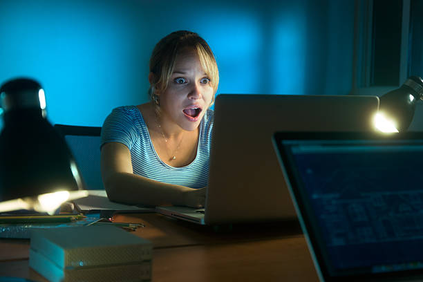 istock Woman Watching Shocking Message On Social Network Late Night 476191130