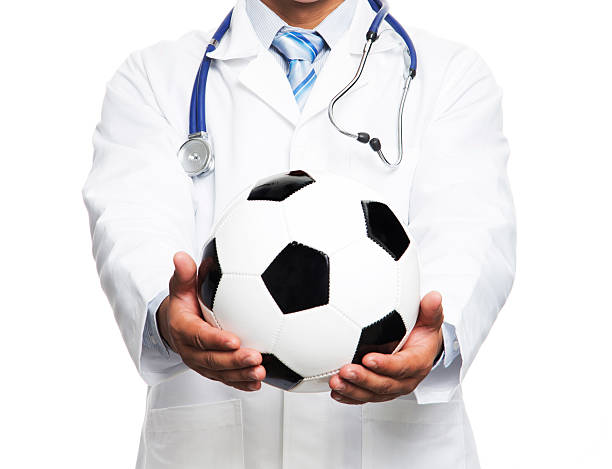 Doctor with soccer ball stock photo