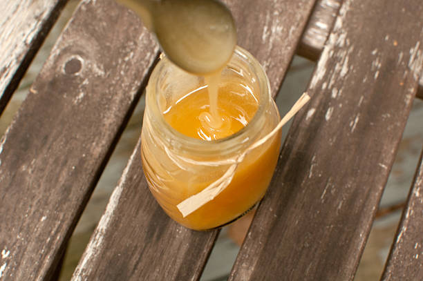 istock Taking a spoon of honey from jar 476192817