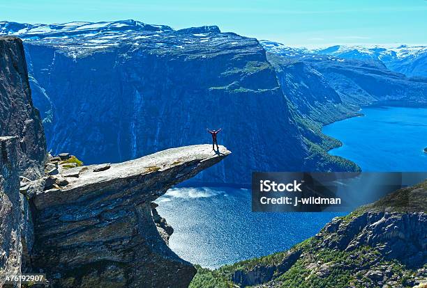 Trolltunga Summer View And Man On Rocks Edge Stock Photo - Download Image Now