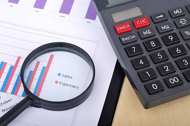 istock Magnifying Glass With Yearly Graph Bar Representing 