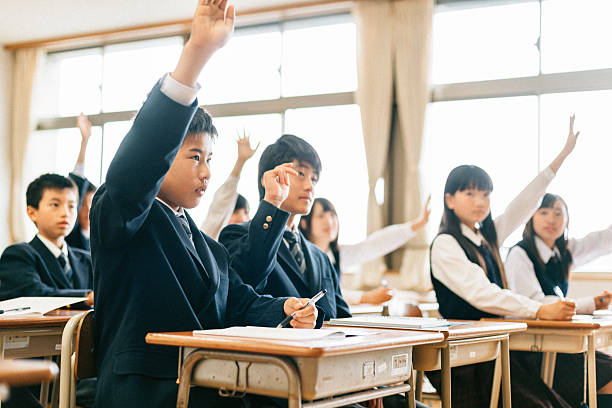 Japanese Junior High School Students Raising hands Japanese Junior High School Students Raising hands in Classroom hand raised classroom student high school student stock pictures, royalty-free photos & images