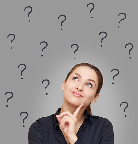 istock Thinking woman looking up on many questions mark 476195197
