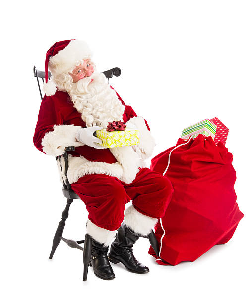 istock Santa Claus Holding Gift Box While Sitting By Bag 476196373