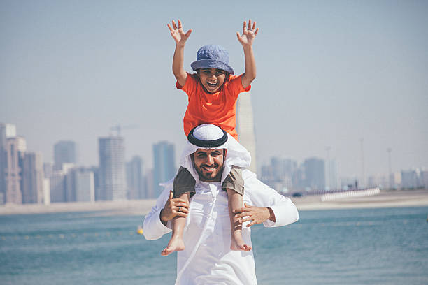 istock Arab father and son having fun at beach 476197046