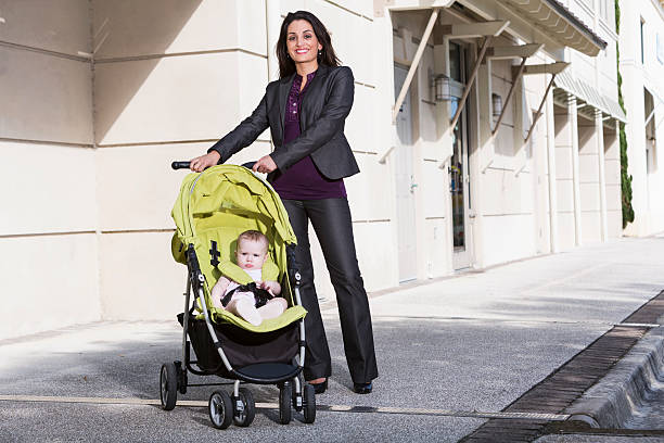 istock Business woman pushing baby stroller 476197429