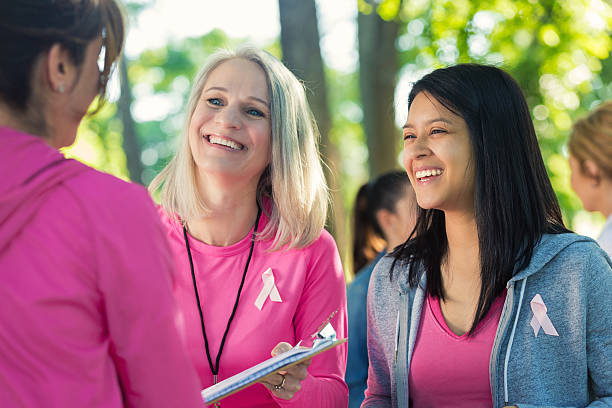 istock Volunteers working at breast cancer awareness race registration table 476197768