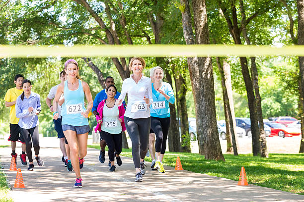 istock Diverse group of runners racing toward marathon finish line 476197796