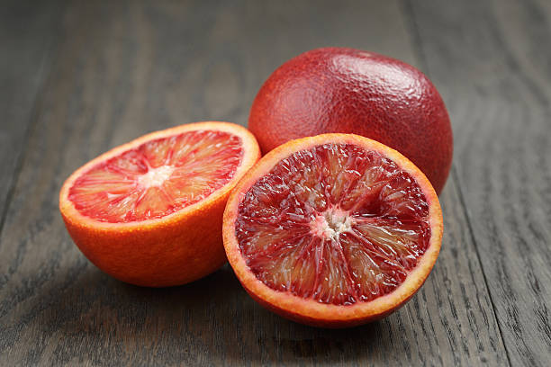 istock red sicilian oranges sliced on wooden table 476198214