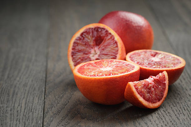 istock red sicilian oranges sliced on wooden table 476198222