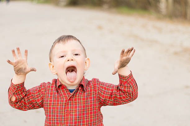 istock Playful little boy sticking out his tongue 476199759
