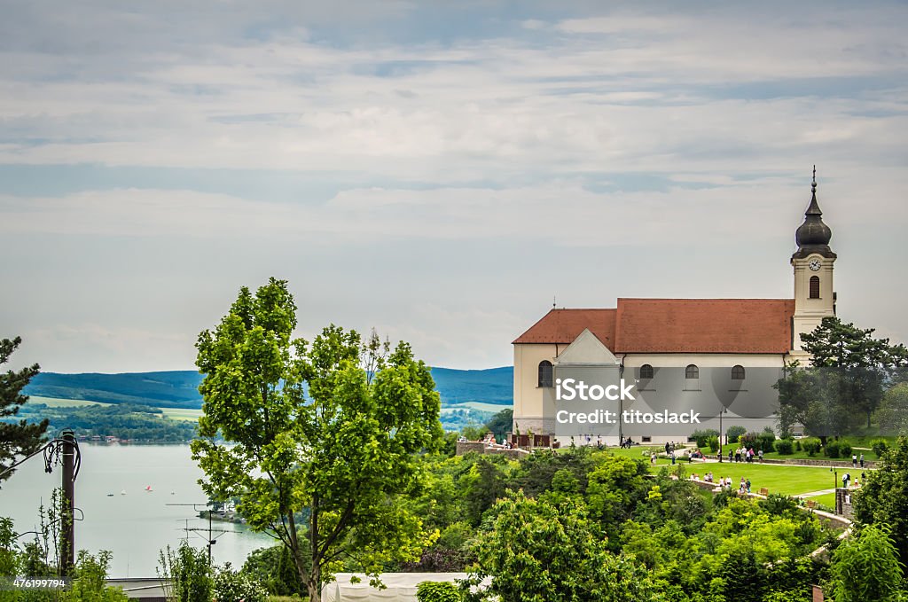 Baroque Spires on Church in Tihany, Hungary Dual Baroque Spires with clocks peeking out over the town of Tihany, Hungary. Veszprém Stock Photo