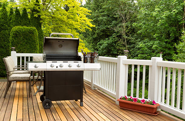 istock Open BBQ cooker and bottled beer on outdoor cedar patio 476202018