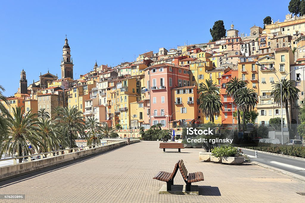 Promenade and town of Menton in France. View of promenade and old medieval town with multicolored houses of Menton on french riviera in France. Menton Stock Photo