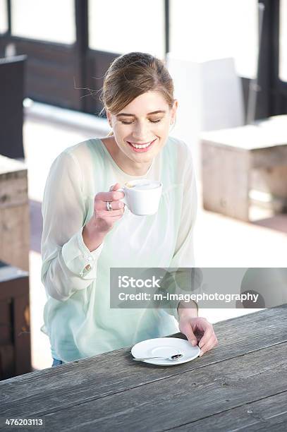 Sorridente Jovem Mulher Desfrutar De Uma Xícara De Café Ao Ar Livre - Fotografias de stock e mais imagens de 25-29 Anos