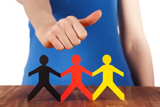 istock hand holding thumb up at paper chain people 476203267
