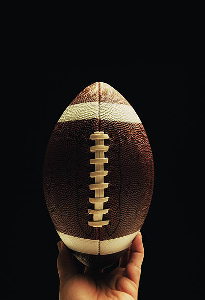 istock football in hand 476204019