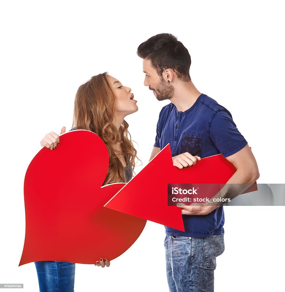 Valentine games sweet and young couple on white background.she is holding big and empty heartshape and he is holding red cupid arrow. 20-29 Years Stock Photo