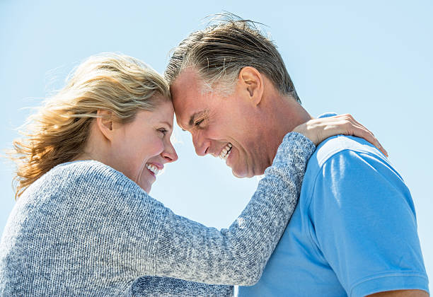 istock Happy Couple Looking At Each Other Against Clear Sky 476204241